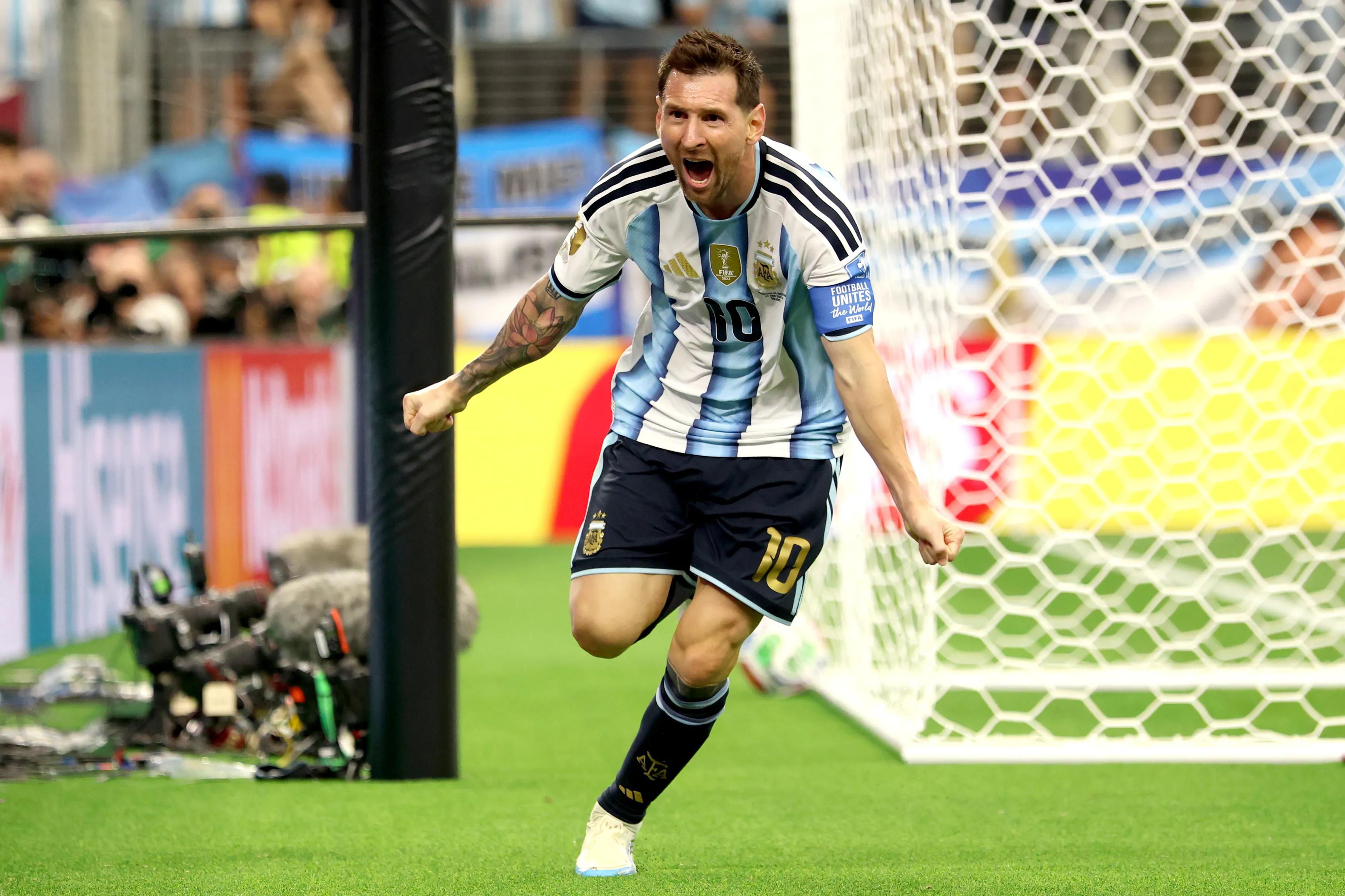 Messi enters record books as Argentina reach knockouts